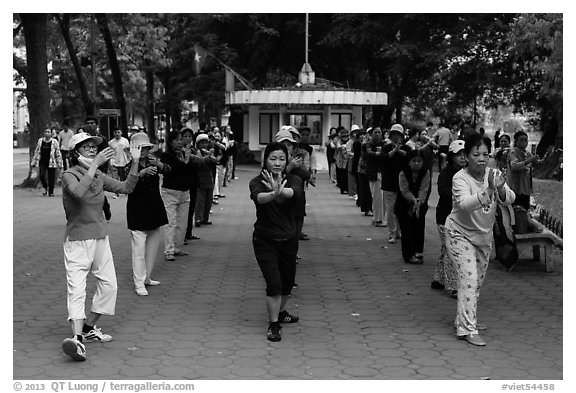 Women practising Tai Chi on shores of Hoang Kiem Lake. Hanoi, Vietnam