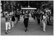 Women practising Tai Chi on shores of Hoang Kiem Lake. Hanoi, Vietnam ( black and white)