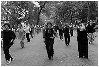 Group of women practising Tai Chi on Hoang Kiem lakeshore. Hanoi, Vietnam ( black and white)