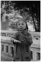 Elderly woman doing Tai Chi moves. Hanoi, Vietnam (black and white)