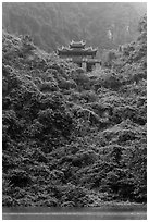 Temple perched on lush hill, Trang An. Ninh Binh,  Vietnam (black and white)