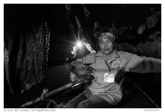 Woman boater in narrow cave passage, Trang An. Ninh Binh,  Vietnam