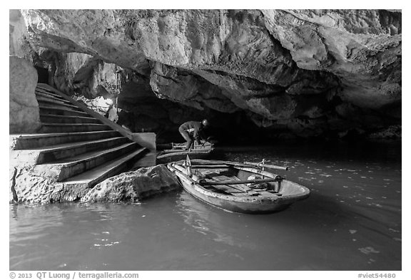 Man readyning a boat inside cave, Trang An. Ninh Binh,  Vietnam (black and white)