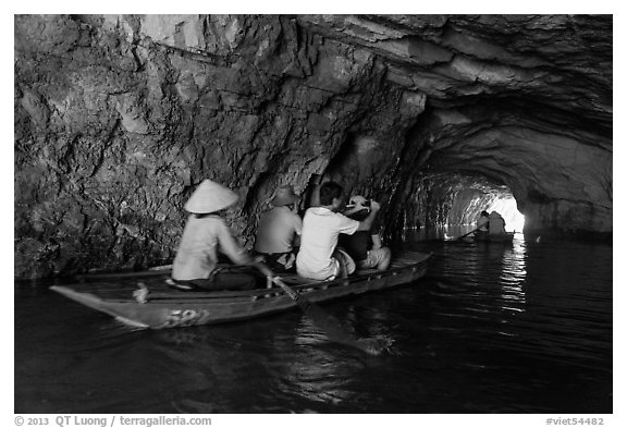 Boat rowed inside grotto passage, Trang An. Ninh Binh,  Vietnam (black and white)