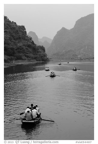 Boats in karstic lanscape of steep cliffs, Trang An. Ninh Binh,  Vietnam (black and white)