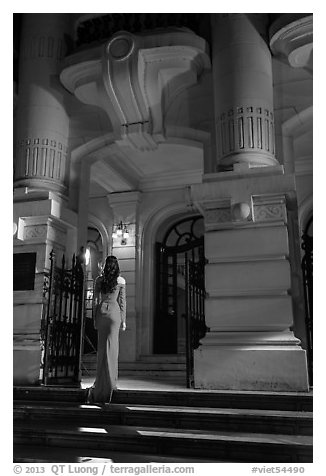 Woman in evening gown entering opera house. Hanoi, Vietnam