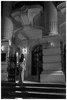 Woman in evening gown entering opera house. Hanoi, Vietnam (black and white)