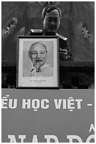 Officer hanging a picture of Ho Chi Minh, Hanoi Citadel. Hanoi, Vietnam (black and white)