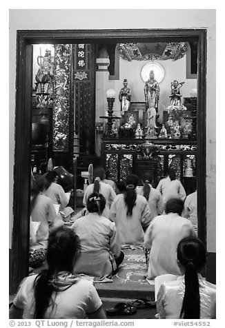 Women worshipping in Phung Son Pagoda, district 11. Ho Chi Minh City, Vietnam (black and white)