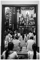 Women worshipping in Phung Son Pagoda, district 11. Ho Chi Minh City, Vietnam (black and white)