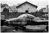 Warplane and wall with barbed wire, War Remnants Museum, district 3. Ho Chi Minh City, Vietnam ( black and white)