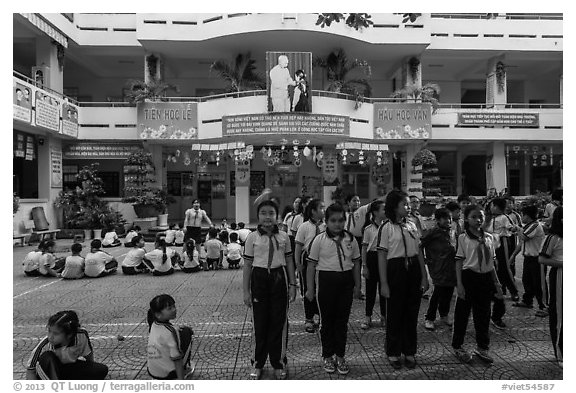 Schoolchildren in school courtyard, district 5. Ho Chi Minh City, Vietnam (black and white)