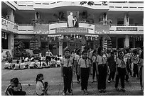 Schoolchildren in school courtyard, district 5. Ho Chi Minh City, Vietnam (black and white)