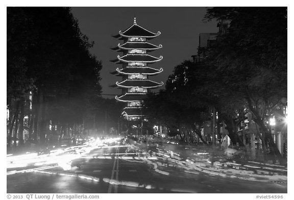 Traffic at night and Quoc Tu Pagoda, district 10. Ho Chi Minh City, Vietnam