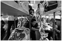 Couple passing baby on sleeper bus. Vietnam (black and white)