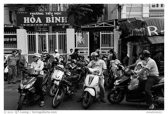 Parents waiting to pick up children in front of school. Ho Chi Minh City, Vietnam (black and white)