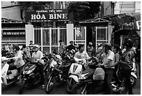 School entrance with parents waiting on motorbikes. Ho Chi Minh City, Vietnam ( black and white)