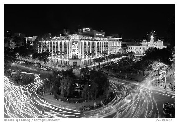 Traffic circle with light trails, Rex Hotel and City Hall. Ho Chi Minh City, Vietnam (black and white)