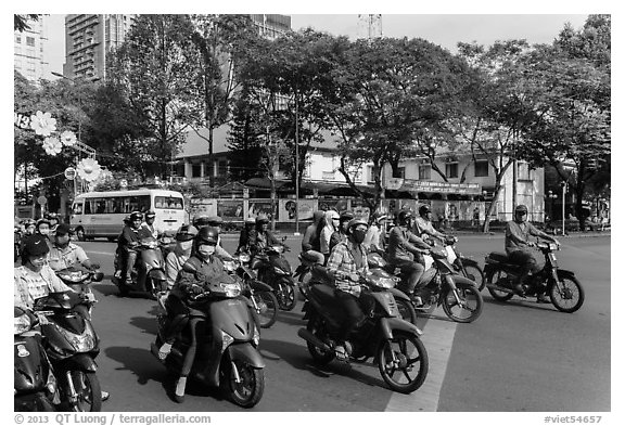 Motorbike riders waiting at intersection. Ho Chi Minh City, Vietnam (black and white)