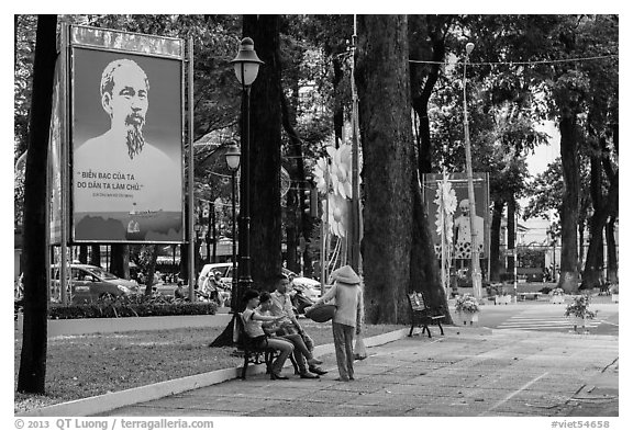 Family chatting with vendor in park. Ho Chi Minh City, Vietnam (black and white)