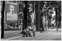 Family chatting with vendor in park. Ho Chi Minh City, Vietnam (black and white)