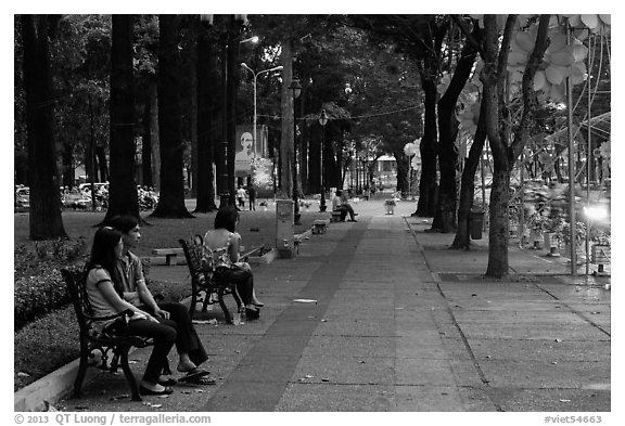 Park sidewalk at dusk. Ho Chi Minh City, Vietnam