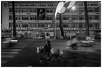 Vendor with bicycle at night. Ho Chi Minh City, Vietnam (black and white)