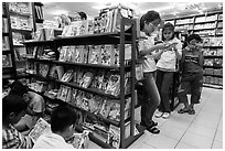 Bookstore shelves and children reading. Ho Chi Minh City, Vietnam (black and white)