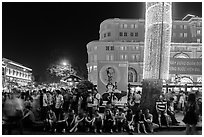 Revellers sitting on street, New Year eve. Ho Chi Minh City, Vietnam ( black and white)