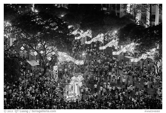 Le Loi boulevard with decorations and crowds from above. Ho Chi Minh City, Vietnam (black and white)