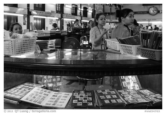 Stamp vending booth in central post office. Ho Chi Minh City, Vietnam (black and white)