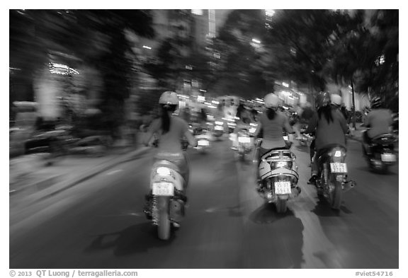 Blurry view from middle of street traffic at night. Ho Chi Minh City, Vietnam