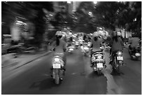 Blurry view from middle of street traffic at night. Ho Chi Minh City, Vietnam ( black and white)