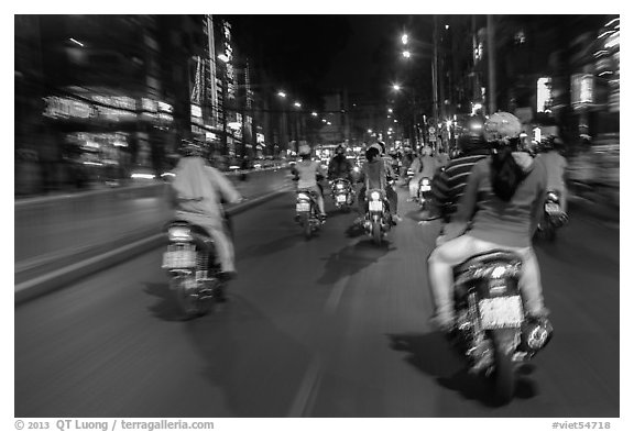 Riders view of motorcycle traffic at night. Ho Chi Minh City, Vietnam (black and white)
