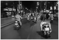 Riders view of motorcycle traffic at night. Ho Chi Minh City, Vietnam (black and white)