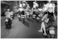 Riders view of motorcycle traffic blurred by speed. Ho Chi Minh City, Vietnam (black and white)