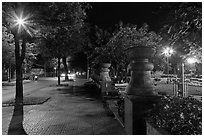 Sidewalk and park at night. Ho Chi Minh City, Vietnam (black and white)
