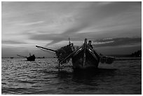 Man on fishing boat at sunset. Mui Ne, Vietnam (black and white)