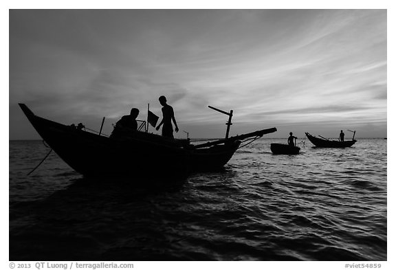 Fishermen on boats at sunset. Mui Ne, Vietnam (black and white)