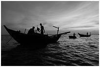 Fishermen on boats at sunset. Mui Ne, Vietnam (black and white)