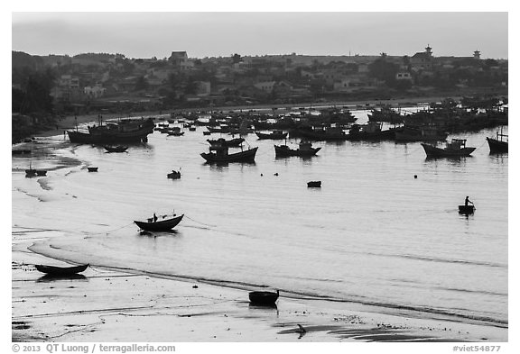 Fishing fleet and village at dawn. Mui Ne, Vietnam (black and white)