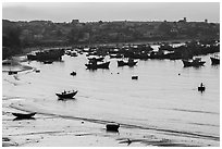 Fishing fleet and village at dawn. Mui Ne, Vietnam (black and white)