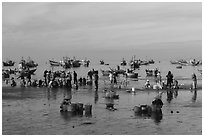 Fishermen, vendors, and boats. Mui Ne, Vietnam (black and white)