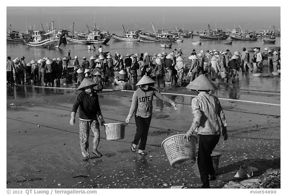 Women carrying baskets with shells. Mui Ne, Vietnam