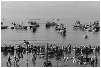 View from above of fishermen, vendors, and fishing fleet. Mui Ne, Vietnam ( black and white)