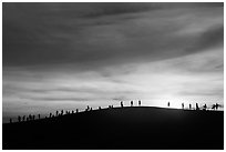 Tourists watching sunset from dune. Mui Ne, Vietnam (black and white)