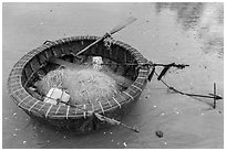 Round coracle boat with fishing gear. Mui Ne, Vietnam (black and white)
