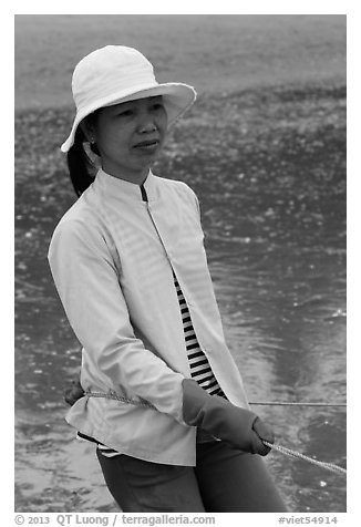 Fisherwoman pulling net line. Mui Ne, Vietnam (black and white)