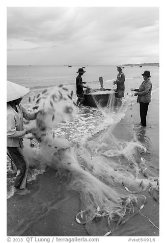 Woman folding fishing net. Mui Ne, Vietnam (black and white)