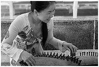 Musician with instrument. My Tho, Vietnam (black and white)